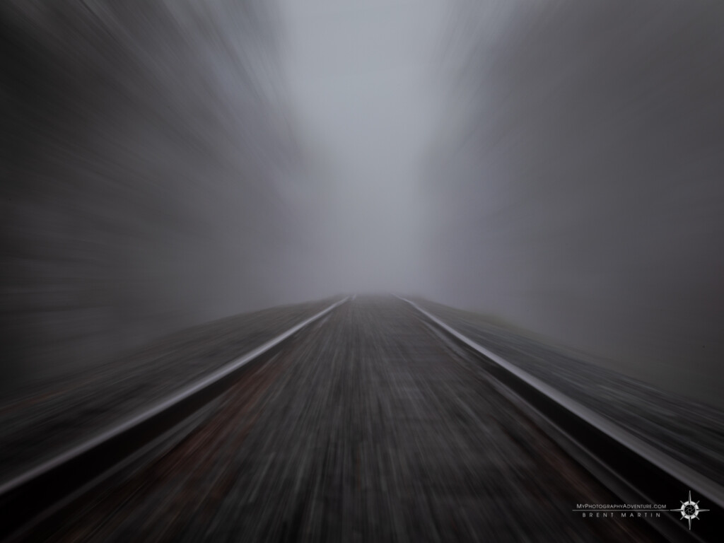 Zoom blur of railroad tracks in fog